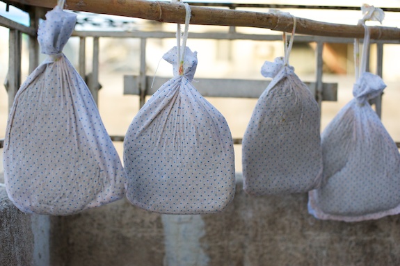 Cloth bags of sujuk (سجق) sausage drying on a balcony in Aleppo
